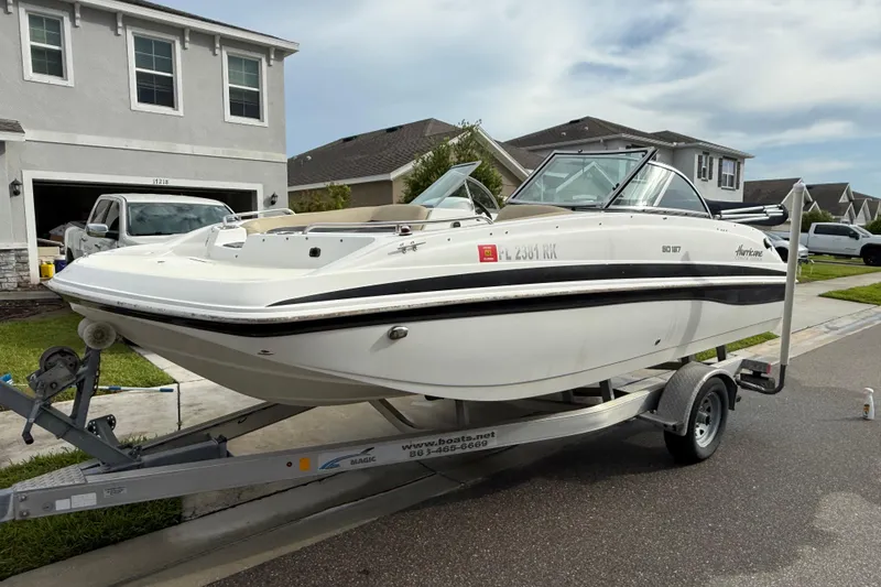 Slide: The Image of 2017 Hurricane SunDeck 187 OB boat on trailer in suburban neighborhood driveway. - 1