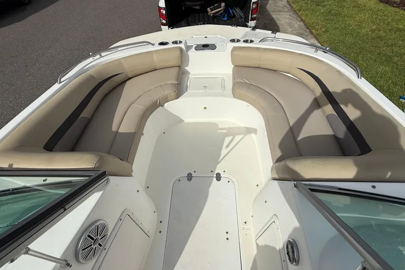 Slide: The Image of 2017 Hurricane SunDeck 187 OB boat interior with beige seating and cup holders. - 18