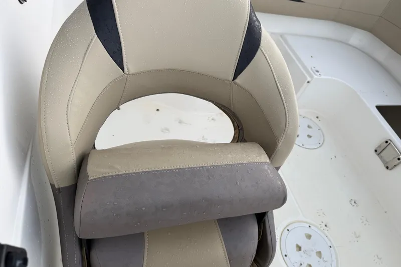 Slide: The Image of 2017 Hurricane SunDeck 187 OB boat seat with beige and gray upholstery, slightly wet. - 15