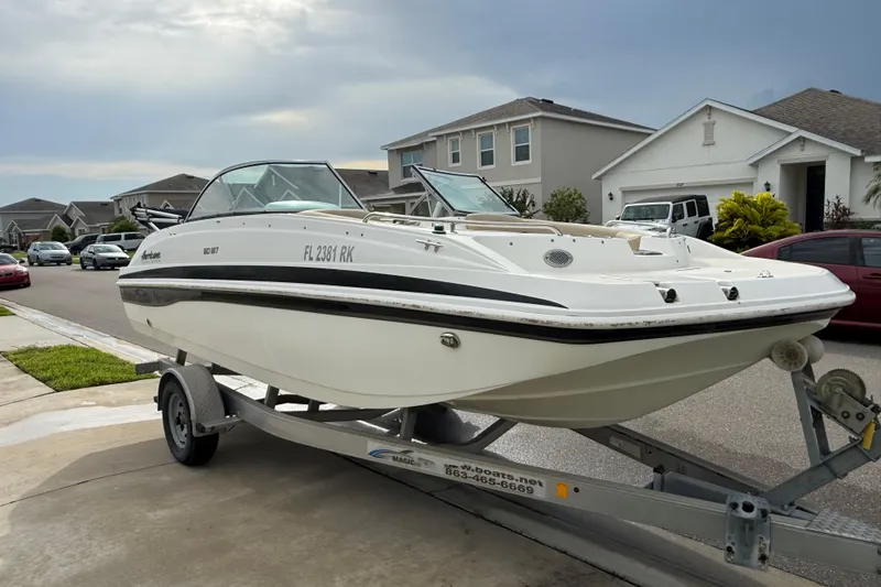 The Image of 2017 Hurricane SunDeck 187 OB boat on trailer in suburban neighborhood. - 0