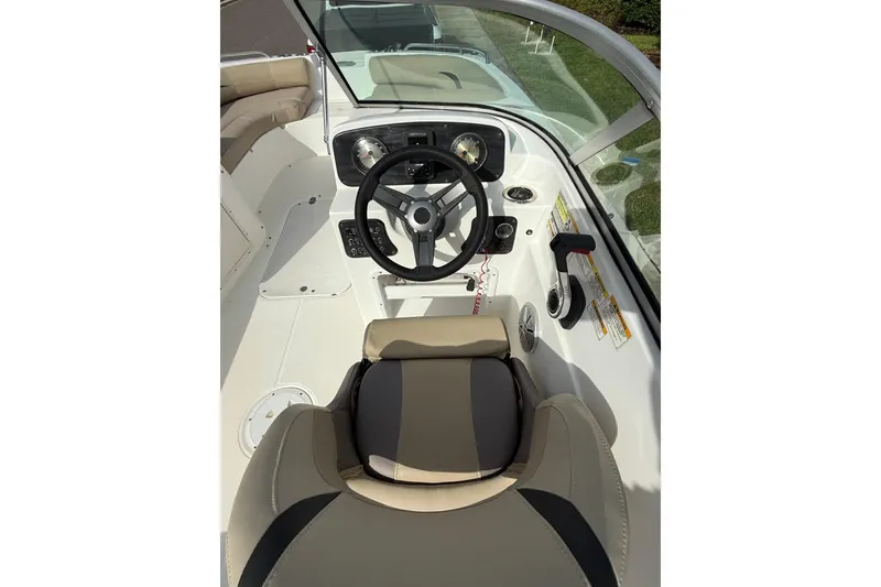 Slide: The Image of 2017 Hurricane SunDeck 187 OB boat cockpit with steering wheel and beige seating. - 13