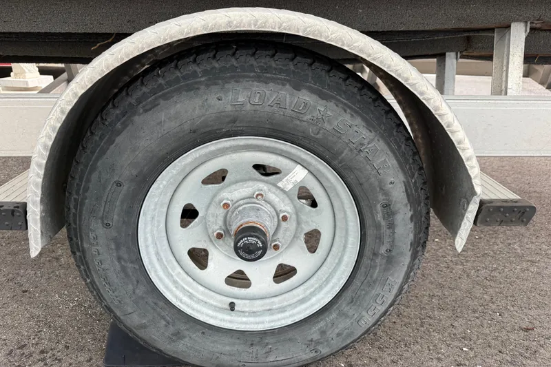 Slide: The Image of Trailer wheel of a 2017 Hurricane SunDeck 187 OB boat, featuring Loadstar tire. - 24