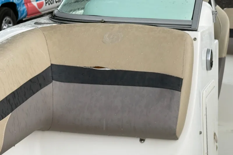 Slide: The Image of 2017 Hurricane SunDeck 187 OB boat seat with visible tear and rain droplets. - 20