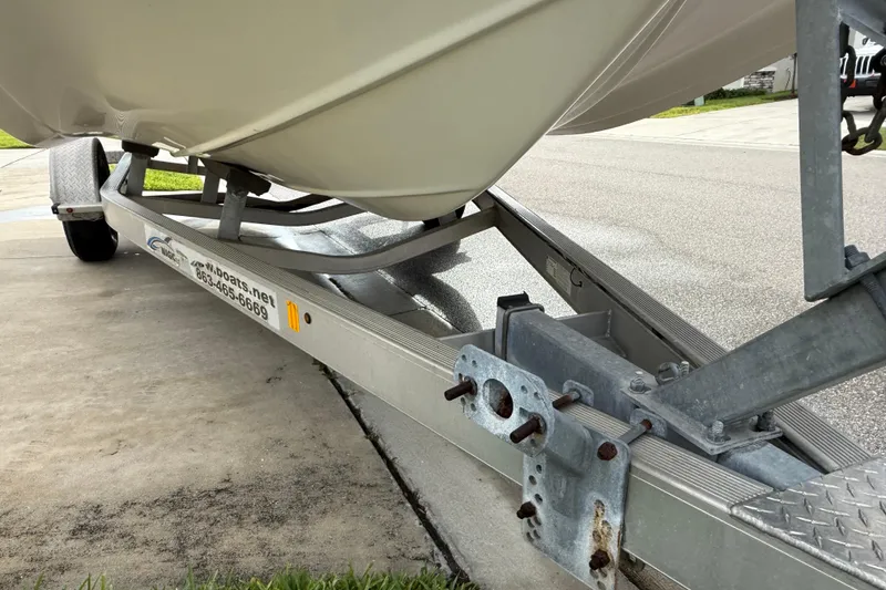 Slide: The Image of 2017 Hurricane SunDeck 187 OB boat on a trailer, parked on a driveway. - 22