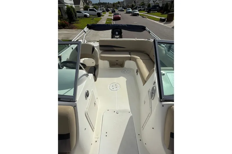 Slide: The Image of 2017 Hurricane SunDeck 187 OB boat interior with seating and steering wheel. - 17