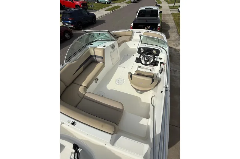 Slide: The Image of 2017 Hurricane SunDeck 187 OB boat interior with beige seating and steering console. - 10