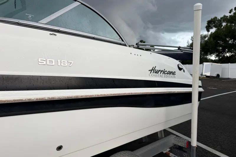 Slide: The Image of 2017 Hurricane SunDeck 187 OB boat on trailer under stormy sky. - 7