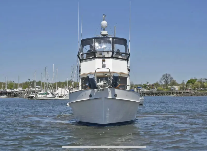 The Image of A 1989 Grand Banks 42 Classic on the water, surrounded by a marina. - 0