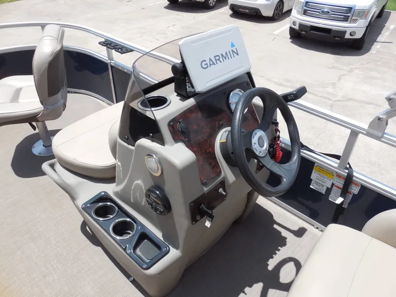 Slide: The Image of The image shows the helm of a 2020 Sun Tracker BASS BUGGY 16XL with Garmin navigation. - 14