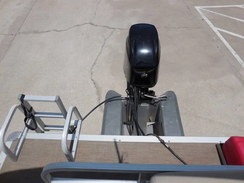 Slide: The Image of A 2020 Sun Tracker BASS BUGGY 16XL with an outboard motor and ladder on a parking lot. - 16