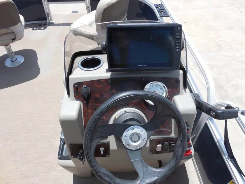 Slide: The Image of Helm of a Sun Tracker BASS BUGGY 16XL with steering wheel and Garmin screen. - 15