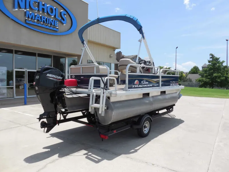 Slide: The Image of A 2020 Sun Tracker BASS BUGGY 16XL on a trailer in front of a building. - 3