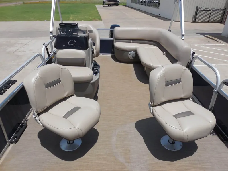Slide: The Image of Interior view of a Sun Tracker BASS BUGGY 16XL pontoon boat with beige seats and steering console. - 10