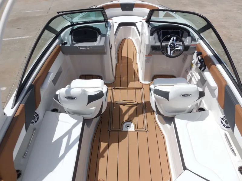 Slide: The Image of The image shows the cockpit of a Chaparral 23 SSi boat with white seats and wood flooring. - 14