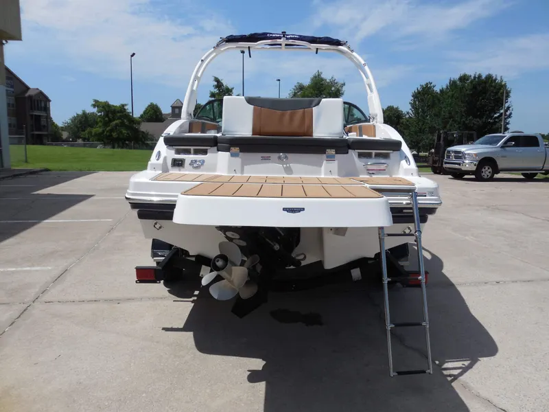 Slide: The Image of The image shows the rear of a Chaparral 23 SSi boat in a parking lot. - 4