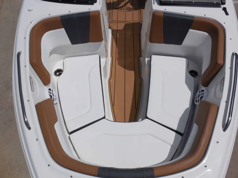 Slide: The Image of Bow seating area of a Chaparral 23 SSi boat with brown and white upholstery. - 18