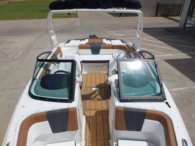 Slide: The Image of The image shows the cockpit of a Chaparral 23 SSi boat with brown and white seating. - 19