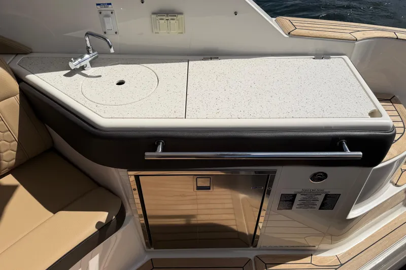 Slide: The Image of 2020 Sea Ray Sundancer 320 Outboard boat kitchenette with sink and storage. - 22