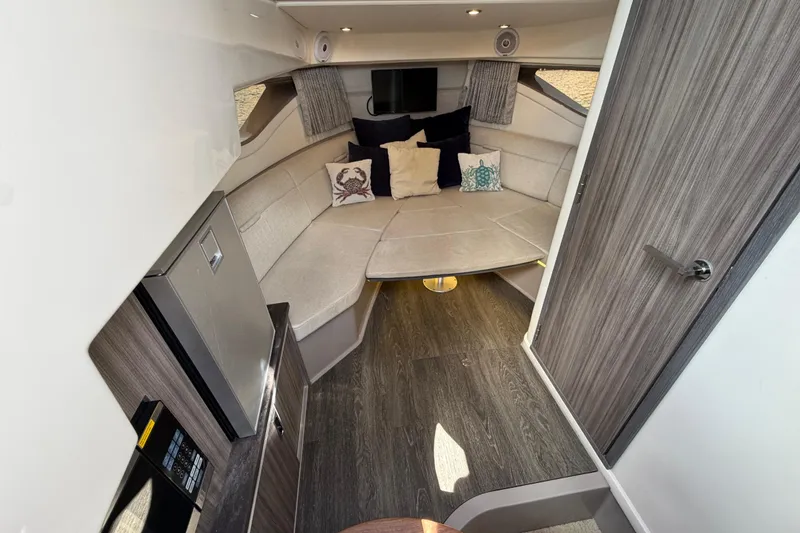 Slide: The Image of 2020 Sea Ray Sundancer 320 Outboard cabin interior with cozy seating and modern design. - 28