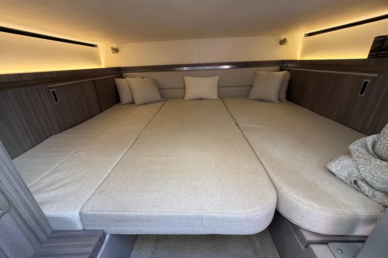 Slide: The Image of 2020 Sea Ray Sundancer 320 Outboard cabin with cozy bedding and ambient lighting. - 35