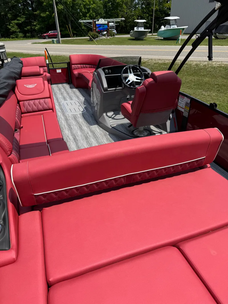 Slide: The Image of Bennington 26LXSSB 2025 with red seating and a modern helm station. - 9
