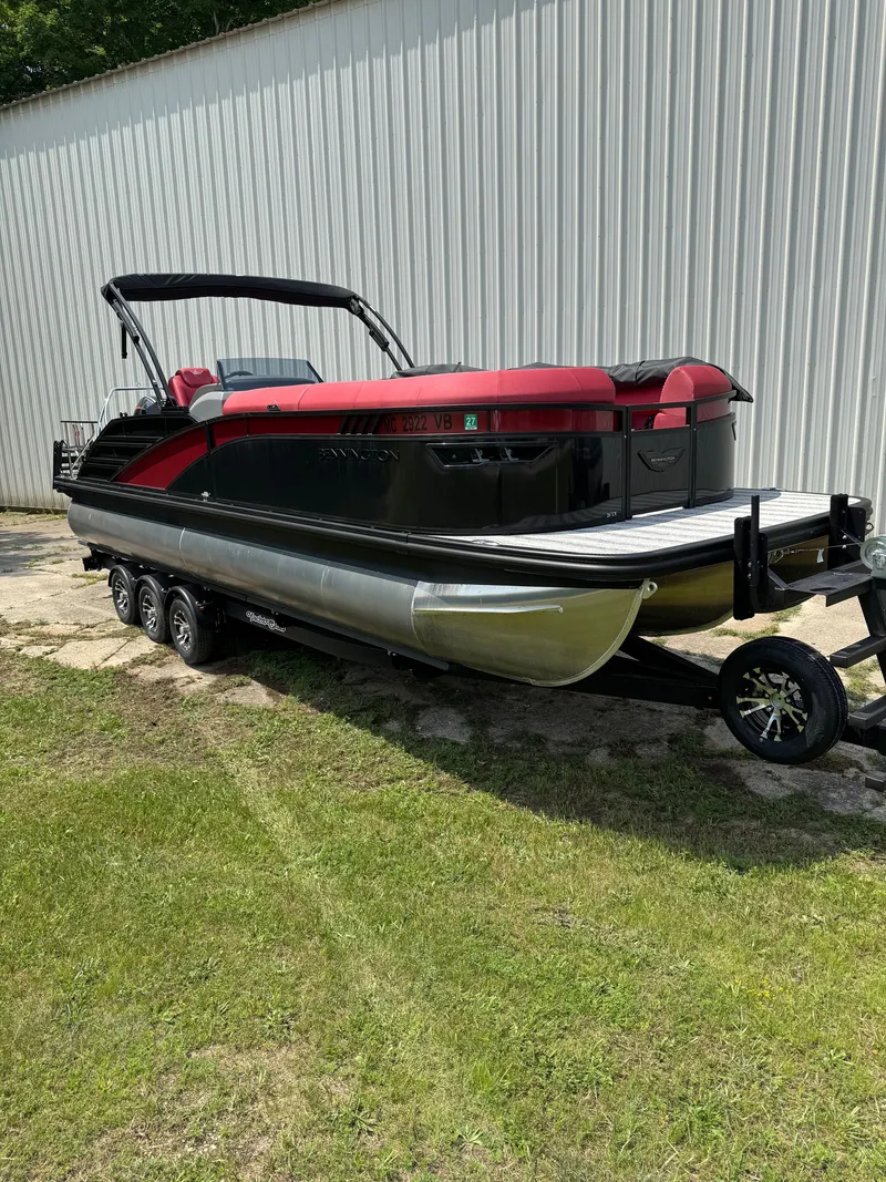 Slide: The Image of A sleek 2025 Bennington 26LXSSB pontoon boat on a trailer beside a building. - 4