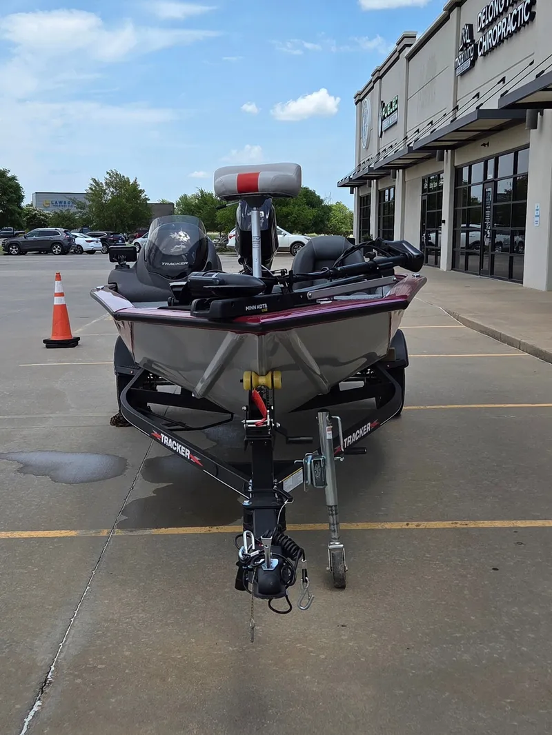 Slide: The Image of A 2022 Tracker Pro Team 175 TXW boat is parked in a lot in front of a building. - 3