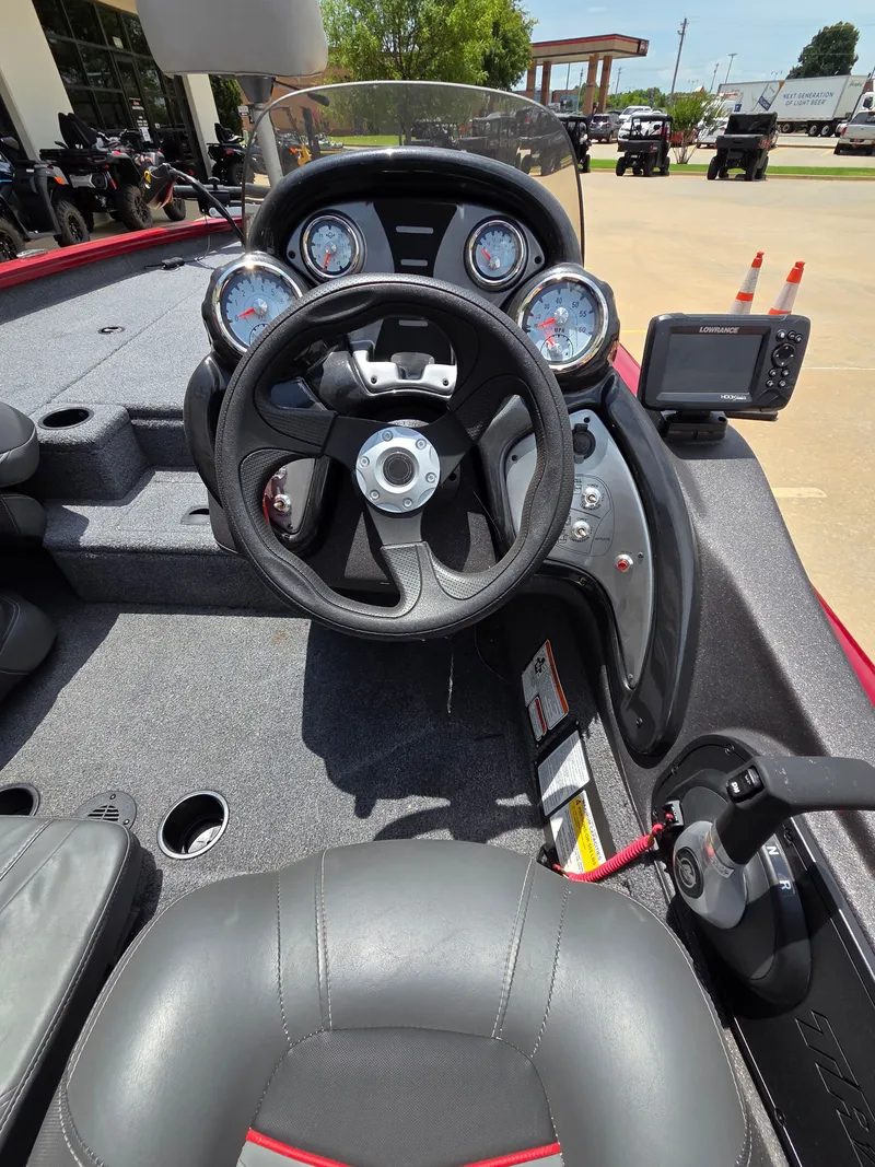 Slide: The Image of Interior view of a 2022 Tracker Pro Team 175 TXW boat with steering wheel and dashboard. - 11