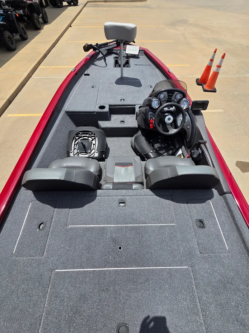 Slide: The Image of The image shows the cockpit of a 2022 Tracker Pro Team 175 TXW boat with gray carpeting. - 9