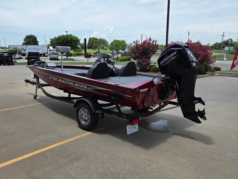 Slide: The Image of A red Tracker boat, model Pro Team 175 TXW, is parked on a lot. - 6