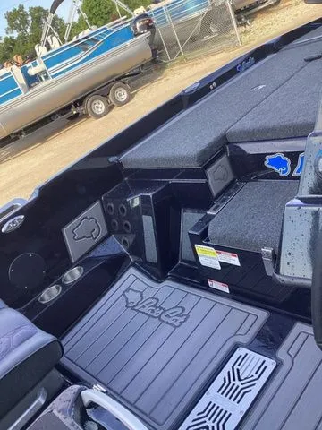 Slide: The Image of The image shows the interior of a Bass Cat Lynx STS boat with gray upholstery and storage. - 40