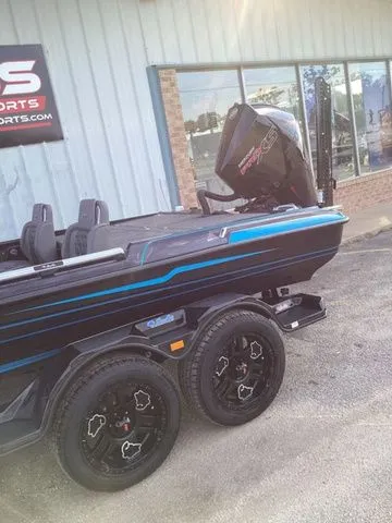 Slide: The Image of A 2026 Bass Cat Lynx STS on a trailer in front of a building. - 14