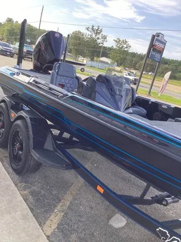Slide: The Image of A 2026 Bass Cat Lynx STS on a trailer. It features a sleek, modern design. - 32