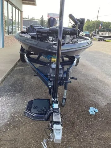 Slide: The Image of A 2026 Bass Cat Lynx STS boat is on a trailer in front of a building. - 23