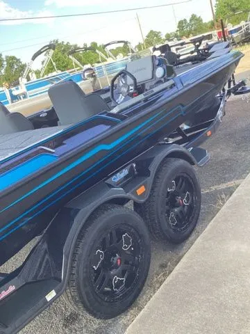 Slide: The Image of A 2026 Bass Cat Lynx STS on a trailer. It features a sleek design with blue accents. - 46