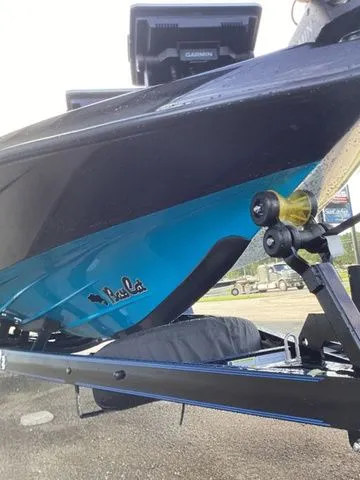Slide: The Image of A 2026 Bass Cat Lynx STS on a trailer, featuring a blue hull and Garmin equipment. - 26
