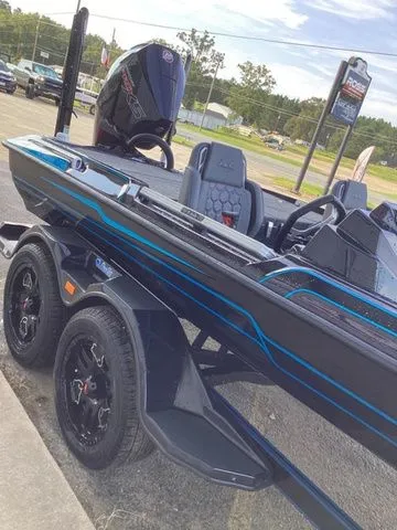 Slide: The Image of A 2026 Bass Cat Lynx STS on a trailer, featuring a blue and black design and powerful engine. - 33