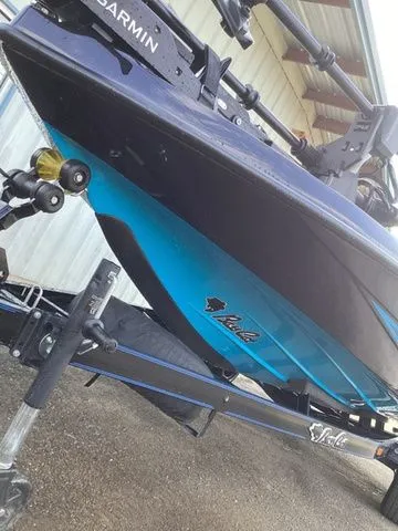 Slide: The Image of A 2026 Bass Cat Lynx STS on a trailer, featuring a blue and black hull. - 18