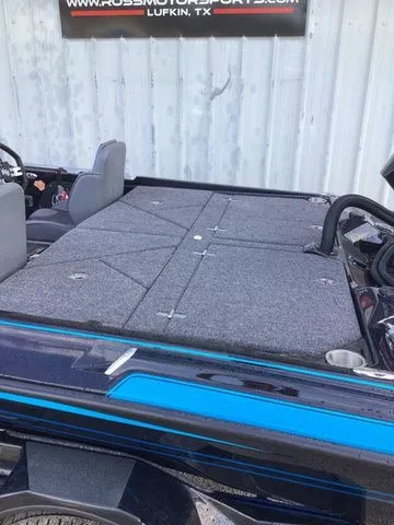 Slide: The Image of The image shows the deck of a 2026 Bass Cat Lynx STS boat with gray carpeting. - 10