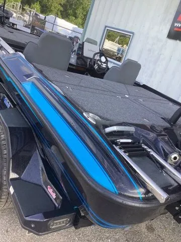 Slide: The Image of The image shows a 2026 Bass Cat Lynx STS boat with gray seats and blue accents. - 7