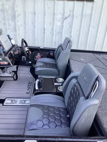 Slide: The Image of Interior of a 2026 Bass Cat Lynx STS with cushioned seats and modern controls. - 11