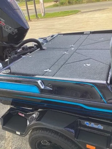 Slide: The Image of The image shows the deck of a 2026 Bass Cat Lynx STS boat with gray carpeting. - 43