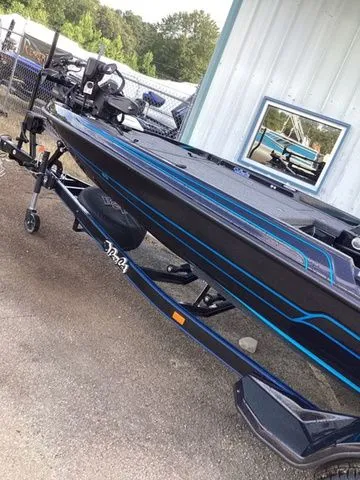 Slide: The Image of A 2026 Bass Cat Lynx STS on a trailer in front of a building. - 16