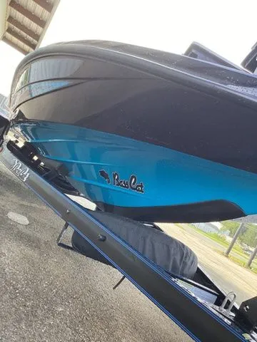 Slide: The Image of The 2026 Bass Cat Lynx STS features a sleek blue hull, resting on a trailer. - 27