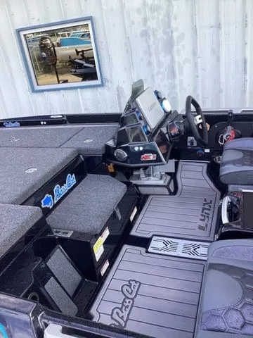 Slide: The Image of The image shows the cockpit of a 2026 Bass Cat Lynx STS with modern instruments and gray upholstery. - 12