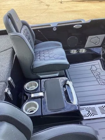 Slide: The Image of The image shows the interior of a Bass Cat Lynx STS with cushioned seats and cup holders. - 39