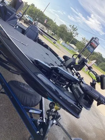 Slide: The Image of A 2026 Bass Cat Lynx STS on a trailer, featuring modern equipment and a Garmin device. - 29