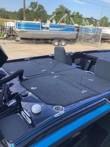 Slide: The Image of The image shows the deck of a 2026 Bass Cat Lynx STS boat with gray carpeting. - 48