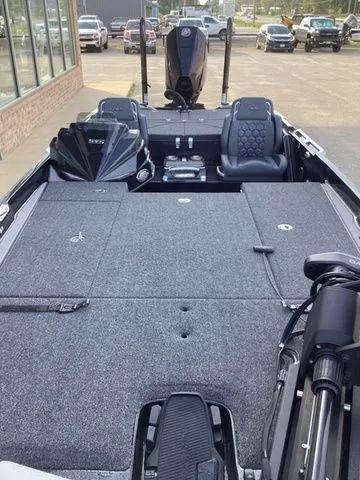 Slide: The Image of The image shows the spacious deck of a Bass Cat Lynx STS boat with modern seating. - 24