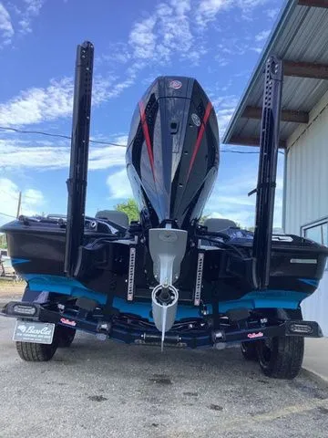 Slide: The Image of A 2026 Bass Cat Lynx STS on a trailer under a covered area. - 4